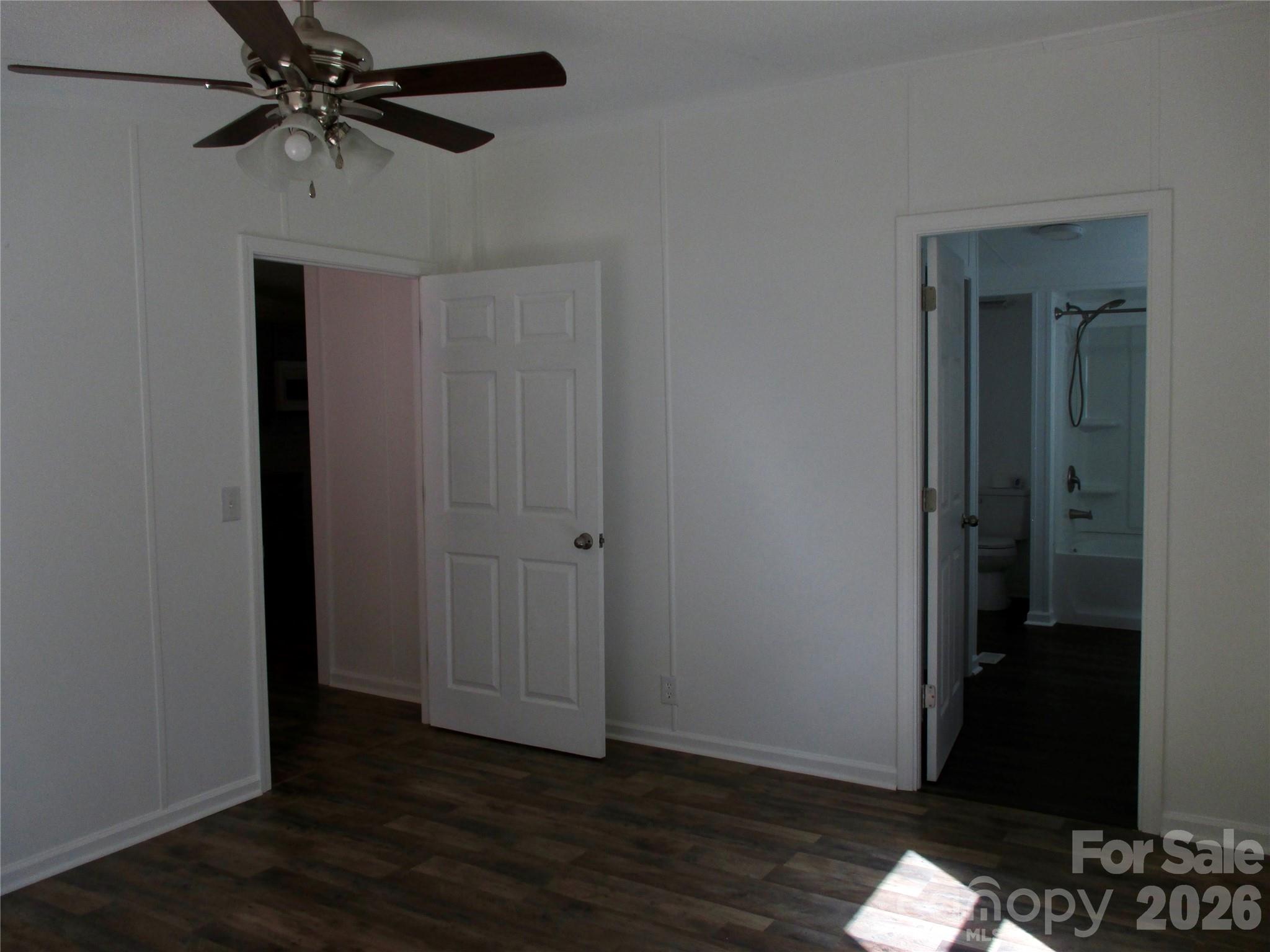 5714 Tipton Road Monroe, NC 28112 - Photo 13 of 26 a view of a room with wooden floor and a ceiling fan