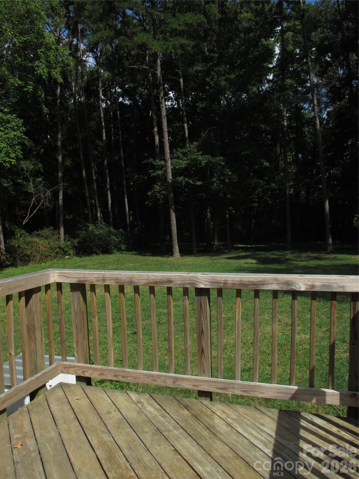 5714 Tipton Road Monroe, NC 28112 - Photo 20 of 26 a view of balcony with wooden floor and trees