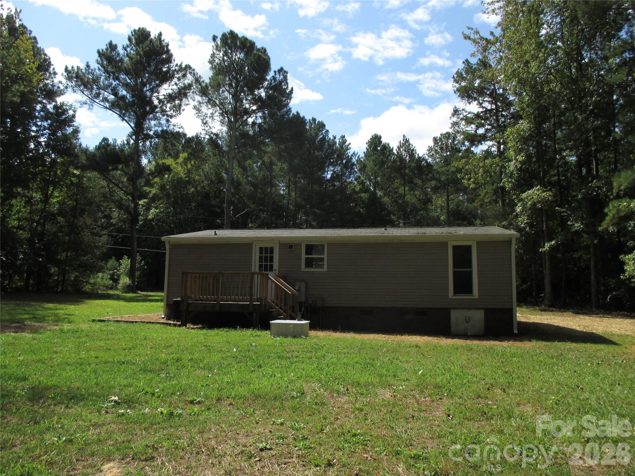 5714 Tipton Road Monroe, NC 28112 - Photo 23 of 26 a backyard of a house with lots of green space