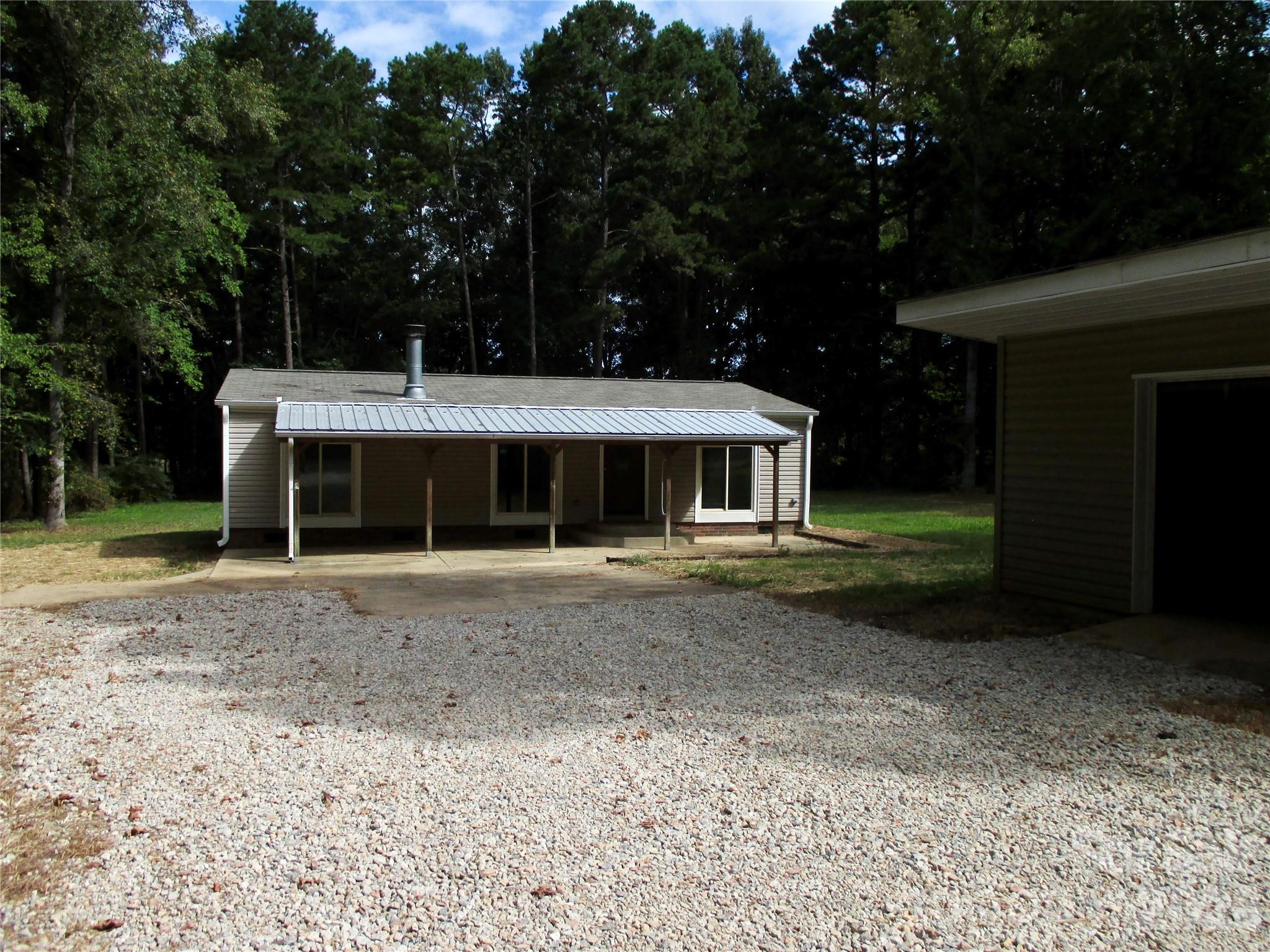 5714 Tipton Road Monroe, NC 28112 - Photo 3 of 26 a front view of a house with a garden and trees