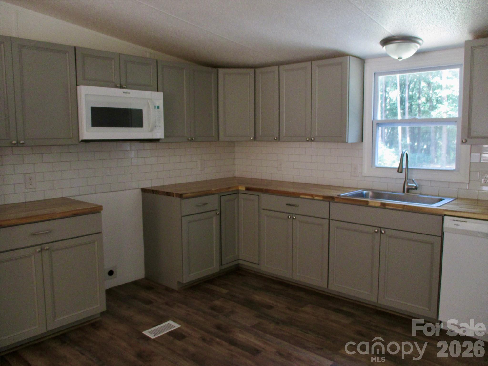 5714 Tipton Road Monroe, NC 28112 - Photo 9 of 26 a kitchen with sink cabinets and window