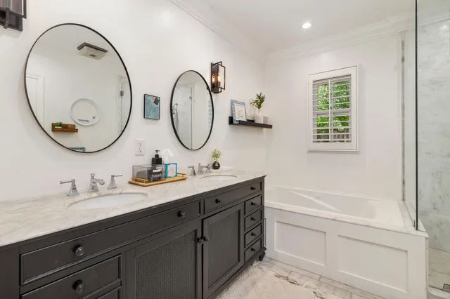 a bathroom with a double vanity sink and a mirror
