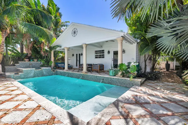 a front view of house with yard and outdoor seating