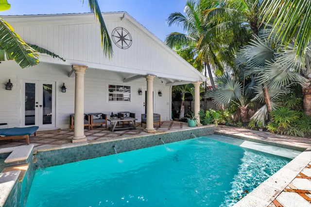 a view of a house with backyard porch and sitting area