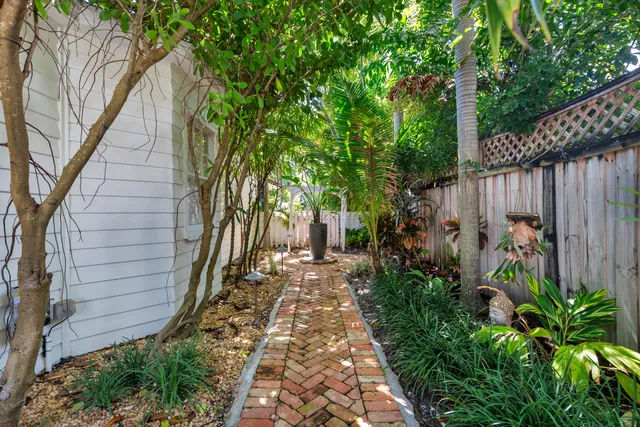 a view of a pathway with a garden