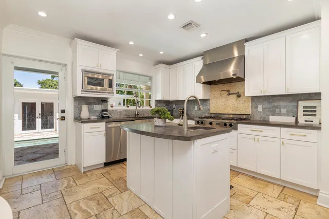 a kitchen with stainless steel appliances granite countertop a sink and cabinets