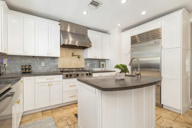 a kitchen with stainless steel appliances granite countertop a sink stove and cabinets