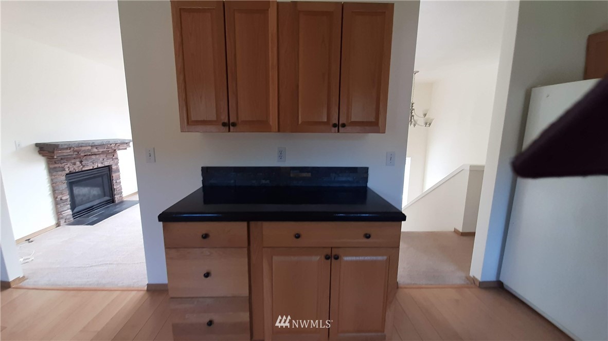 333 East Springfield Loop Shelton, WA 98584 - Photo 11 of 27 a kitchen with granite countertop a stove and a white refrigerator