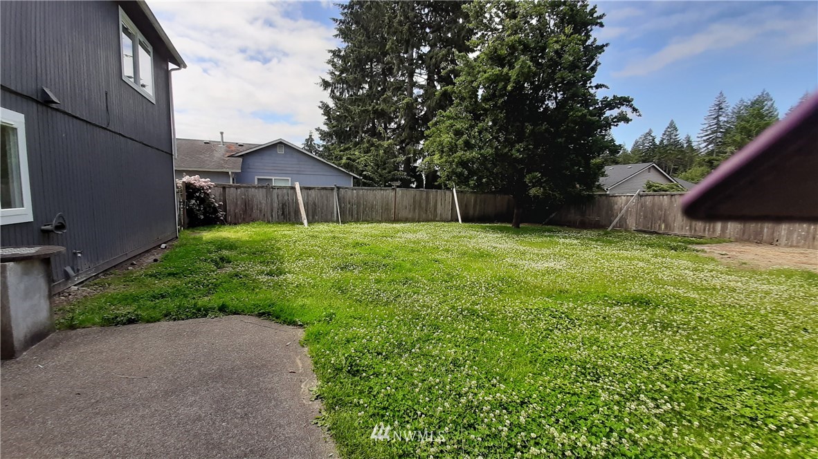 333 East Springfield Loop Shelton, WA 98584 - Photo 13 of 27 a backyard of a house with plants and large tree