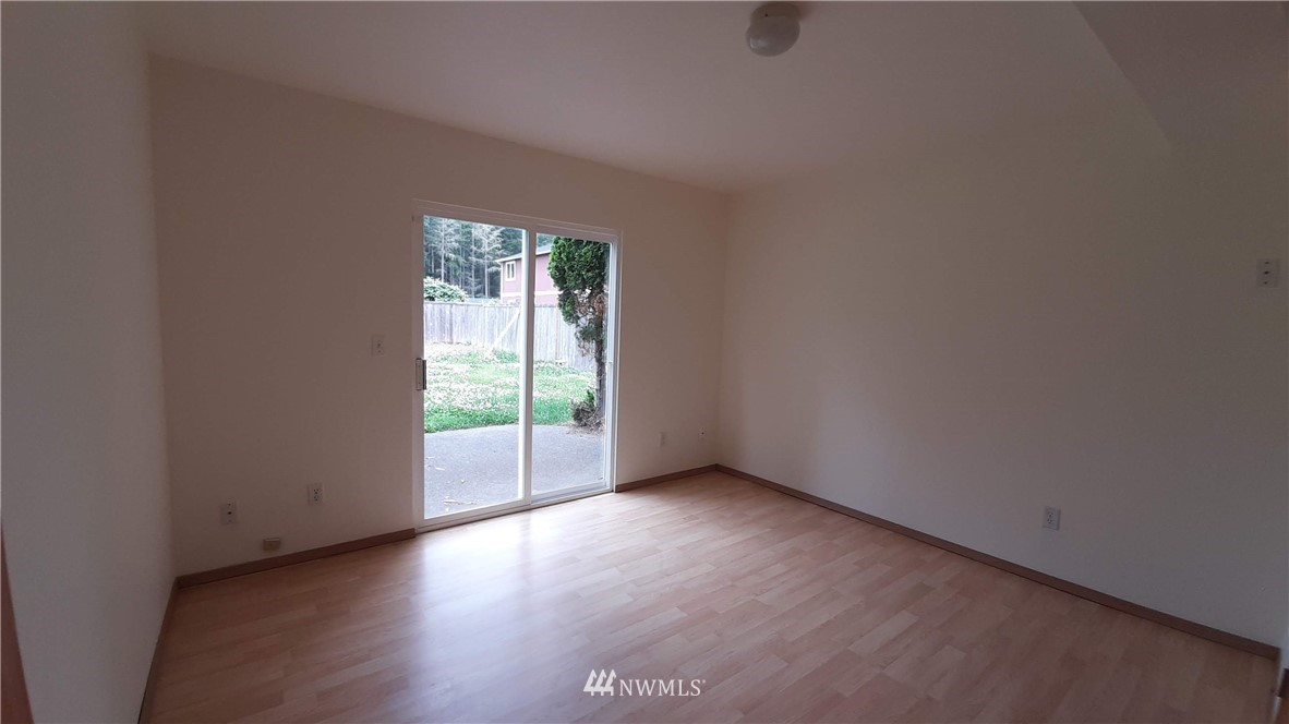 333 East Springfield Loop Shelton, WA 98584 - Photo 17 of 27 an empty room with wooden floor and windows