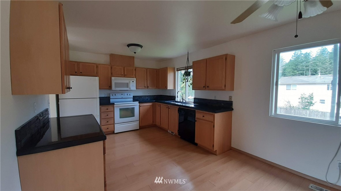 333 East Springfield Loop Shelton, WA 98584 - Photo 7 of 27 a kitchen with stainless steel appliances granite countertop a stove a sink and a refrigerator