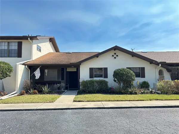 a front view of house with yard and seating space