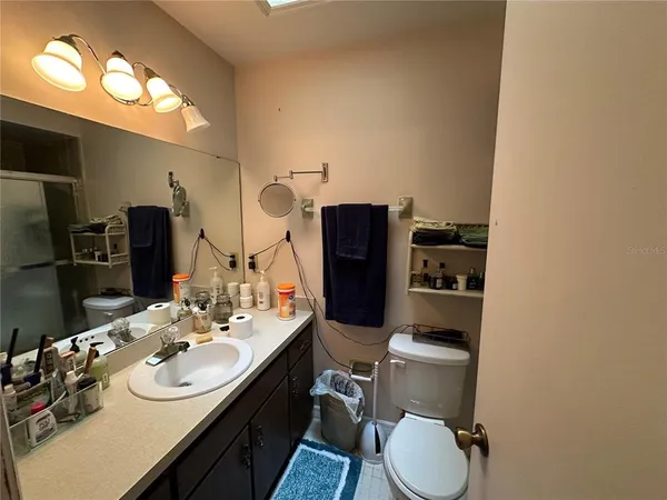 a bathroom with a toilet sink and mirror
