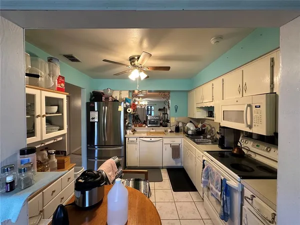 a kitchen with a sink stainless steel appliances and cabinets