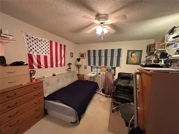 a living room with furniture and paintings on the wall