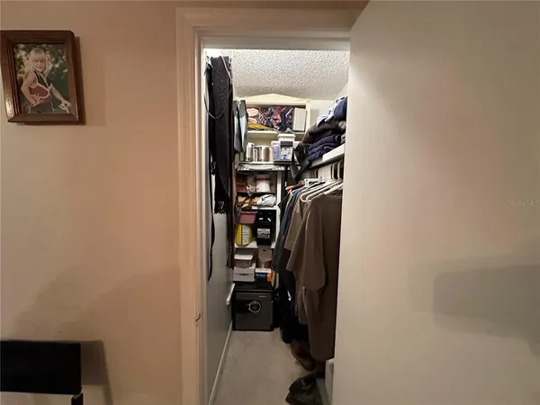 a view of walk in closet with clothes