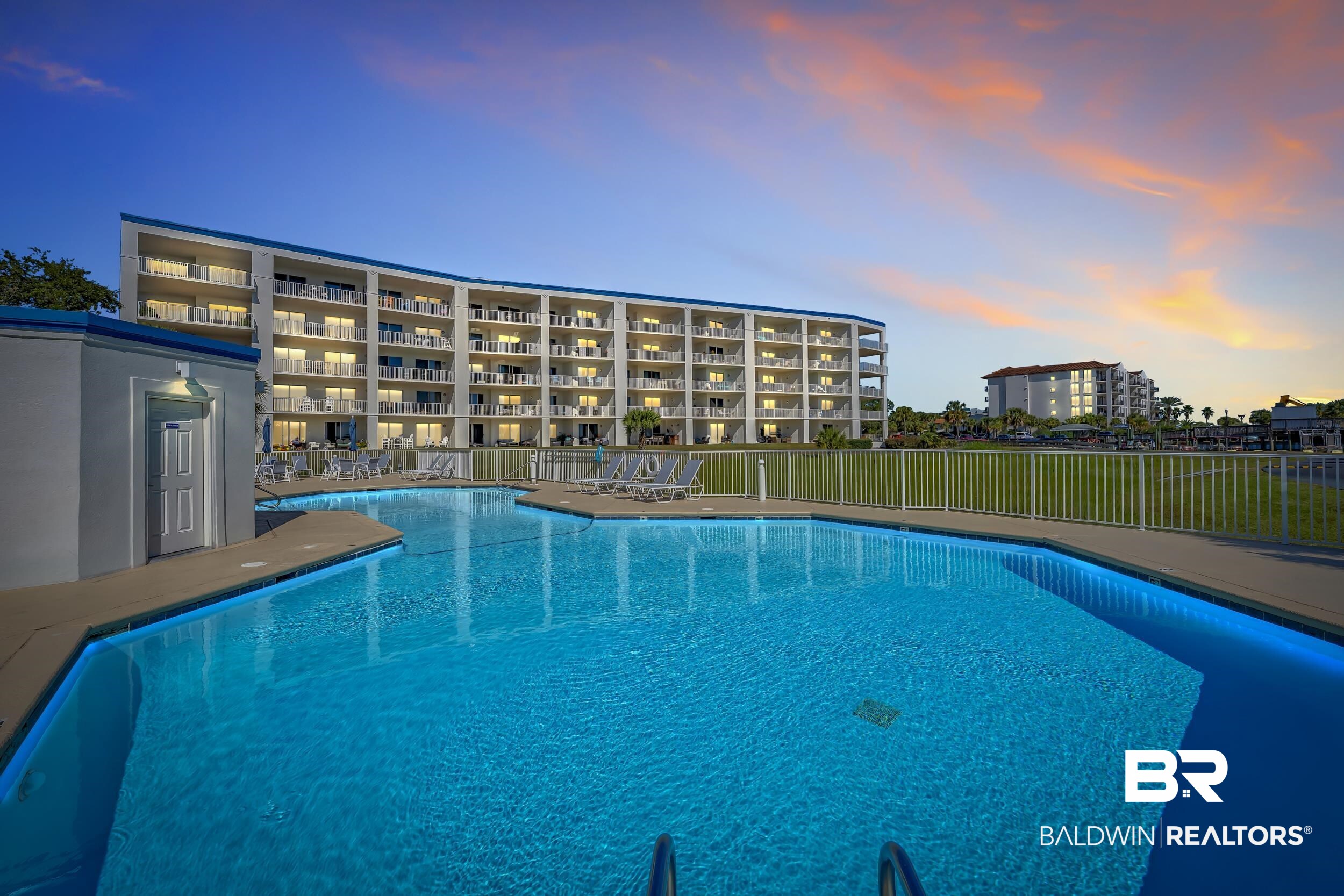 27282 Canal Road, Unit 104 Orange Beach, AL 36561 - Photo 62 of 79 Pool at dusk with a community pool