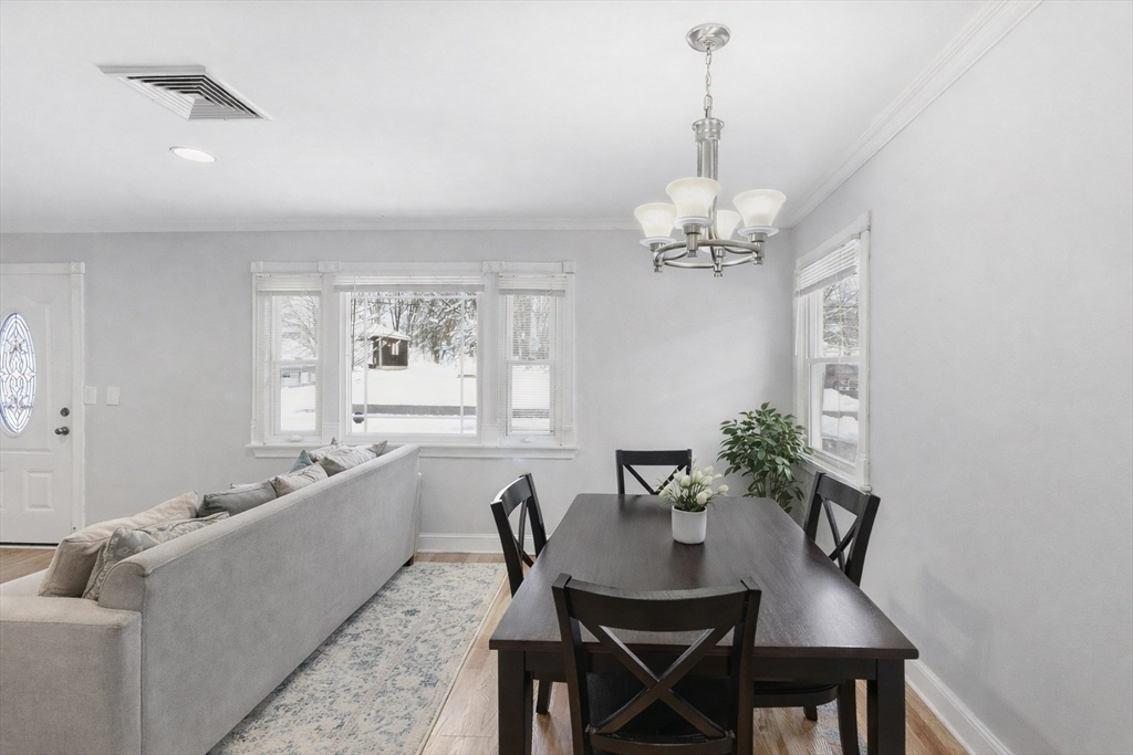 106 Baldwin Avenue Framingham, MA 01701 - Photo 3 of 13 a dining room with furniture a chandelier and window