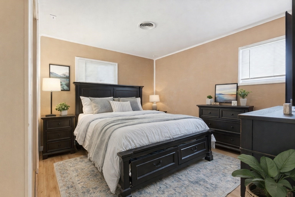 106 Baldwin Avenue Framingham, MA 01701 - Photo 5 of 13 a bedroom with a bed and window