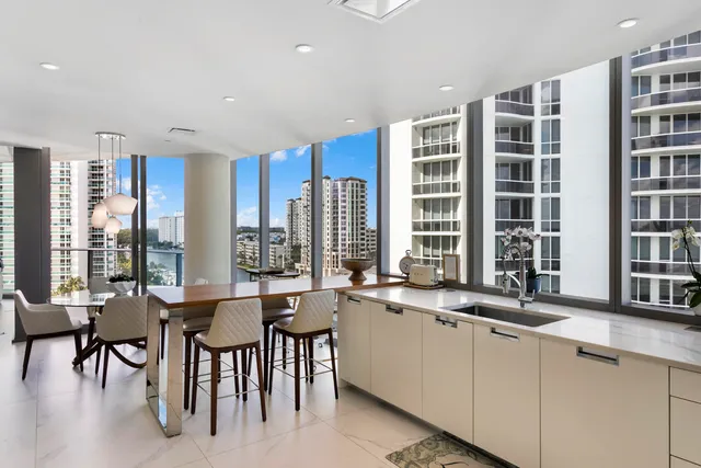 a kitchen with a table chairs sink and cabinets