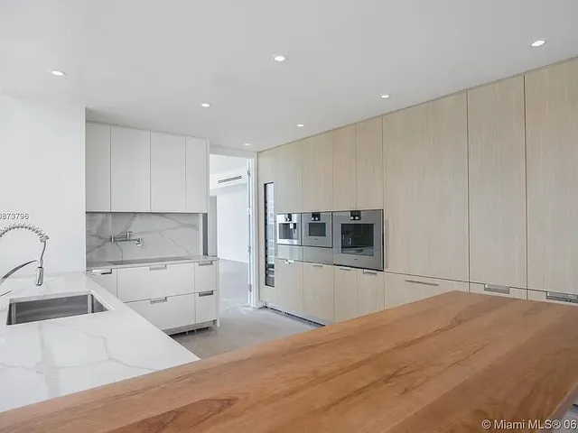 a large white kitchen with a sink