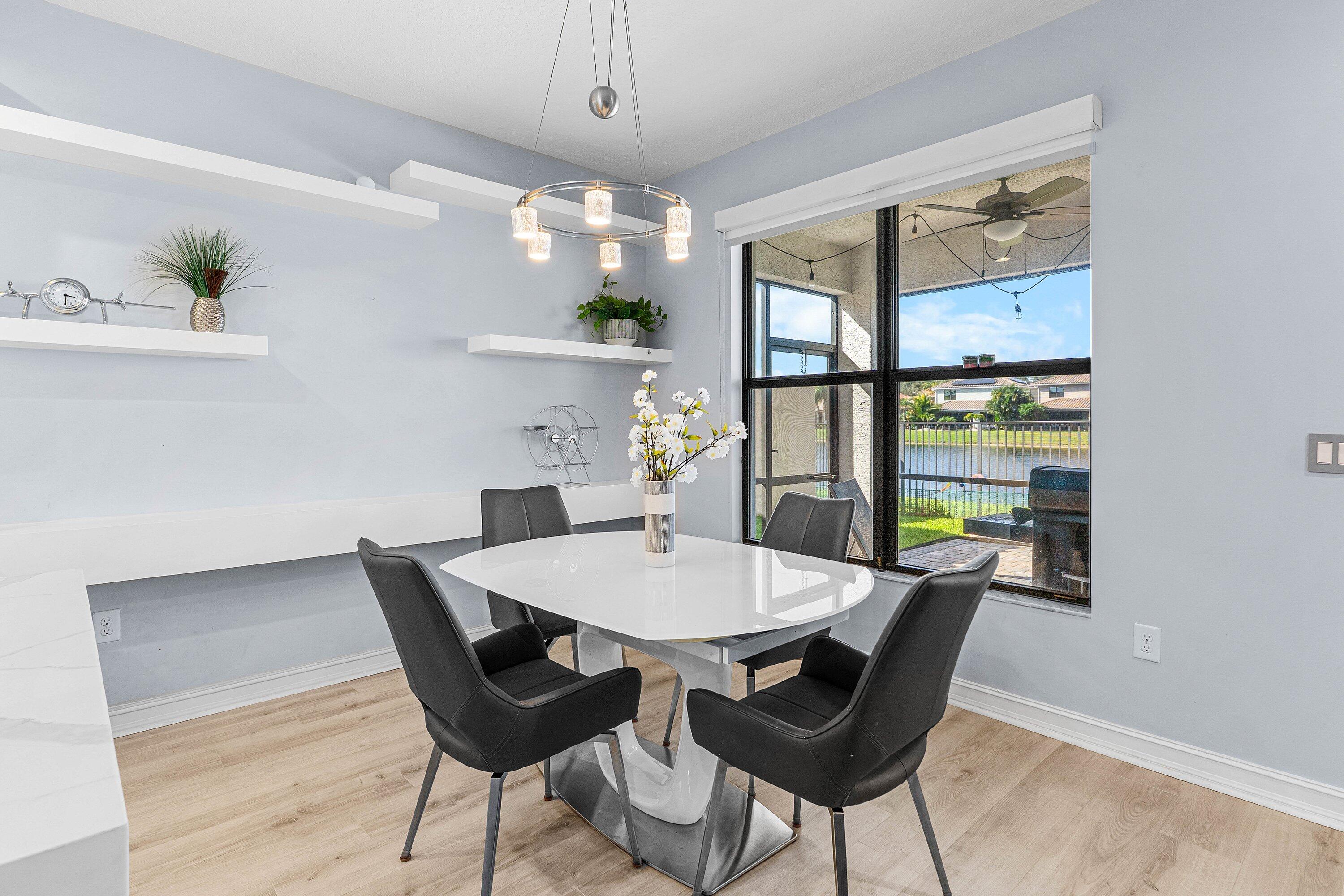 14125 Rock Salt Road Delray Beach, FL 33446 - Photo 11 of 55 a view of a dining room with furniture window and wooden floor