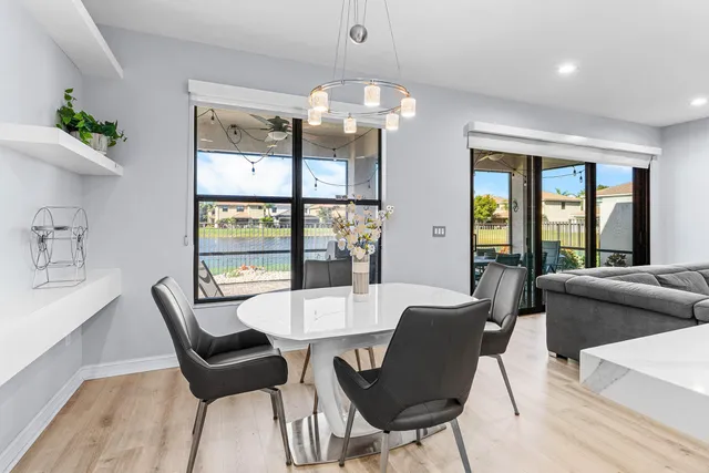 a view of a dining room with furniture large windows and wooden floor