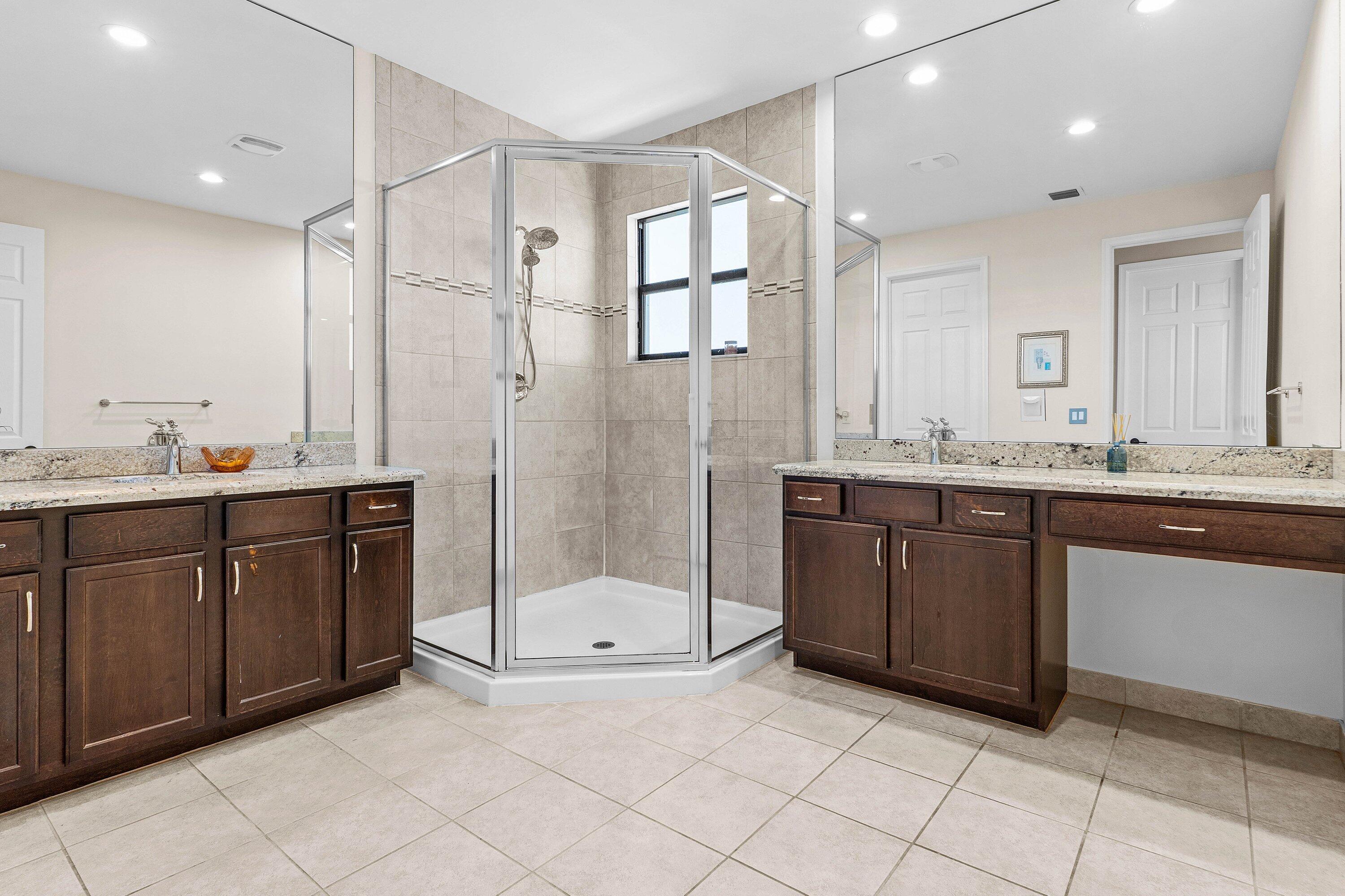 14125 Rock Salt Road Delray Beach, FL 33446 - Photo 18 of 55 a bathroom with a sink vanity granite tub shower and mirror