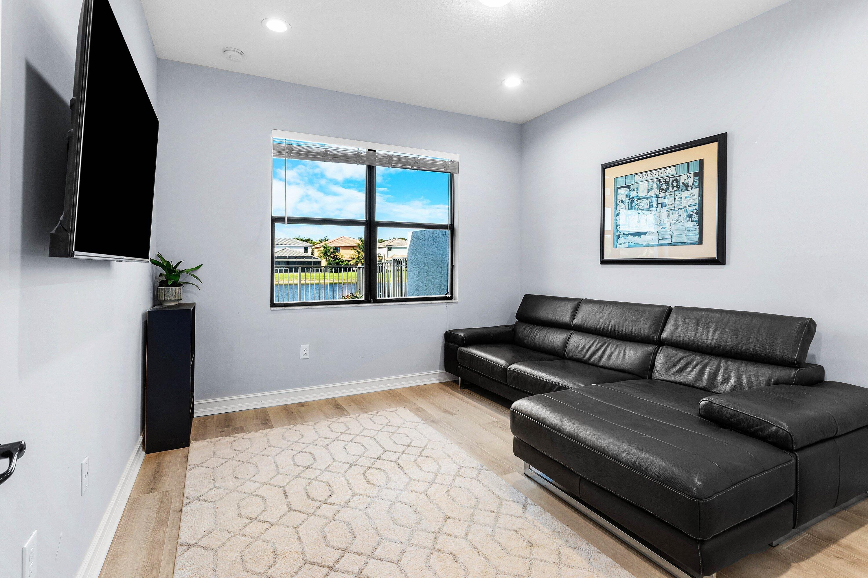 14125 Rock Salt Road Delray Beach, FL 33446 - Photo 25 of 55 a living room with furniture and a flat screen tv