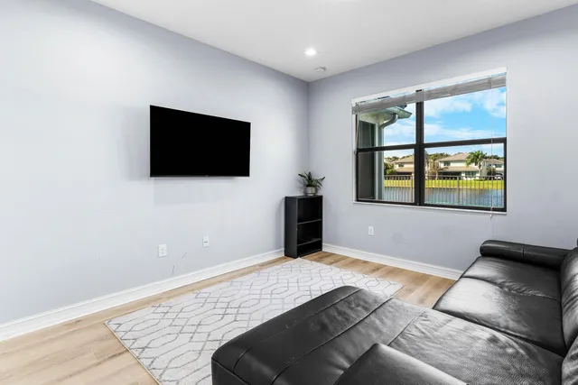 a bathroom with a granite countertop sink a toilet and a mirror