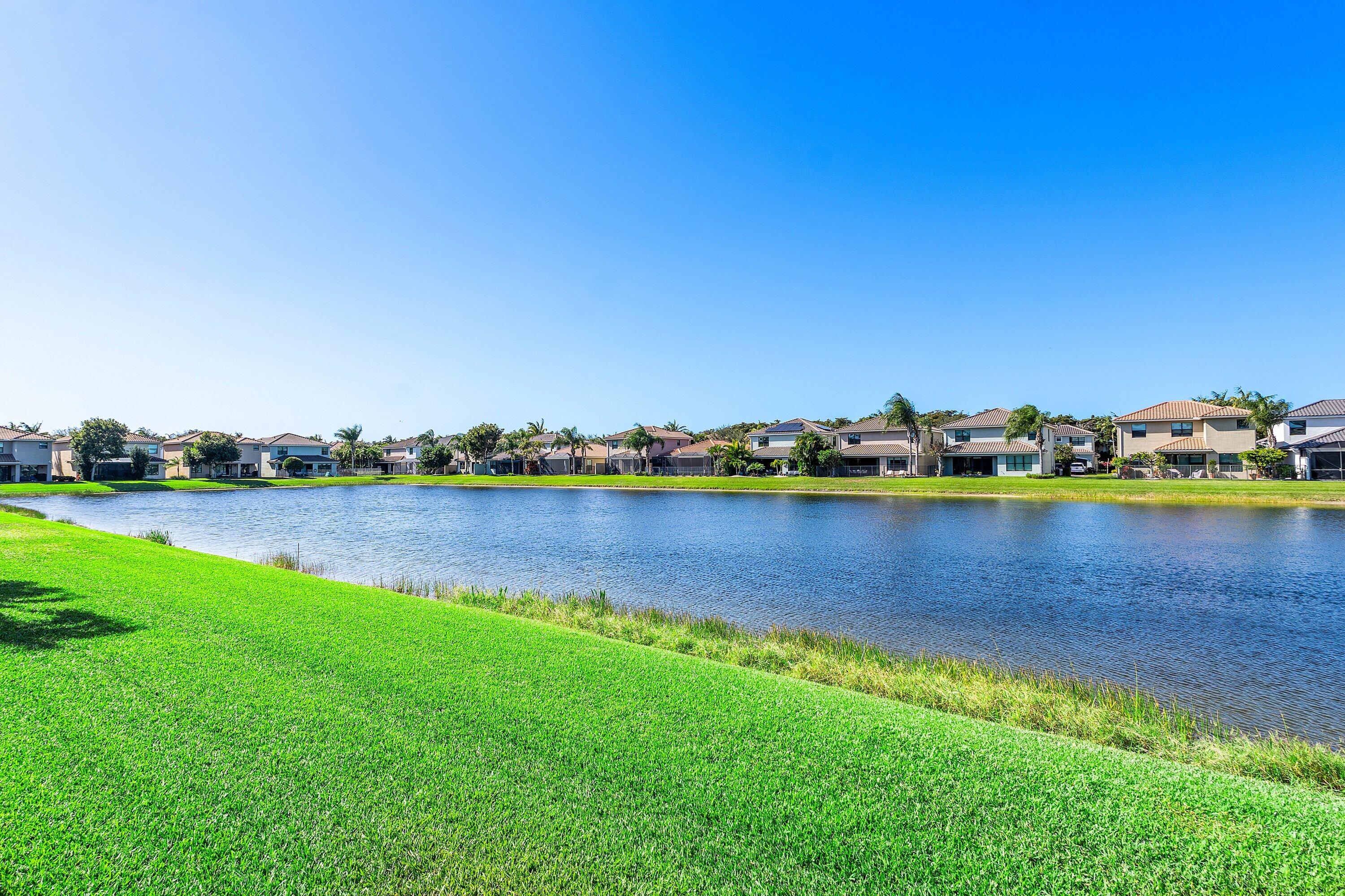 14125 Rock Salt Road Delray Beach, FL 33446 - Photo 32 of 55 a view of a lake with houses in the back
