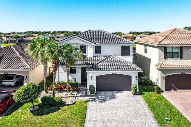 an aerial view of a house with a swimming pool yard and outdoor seating