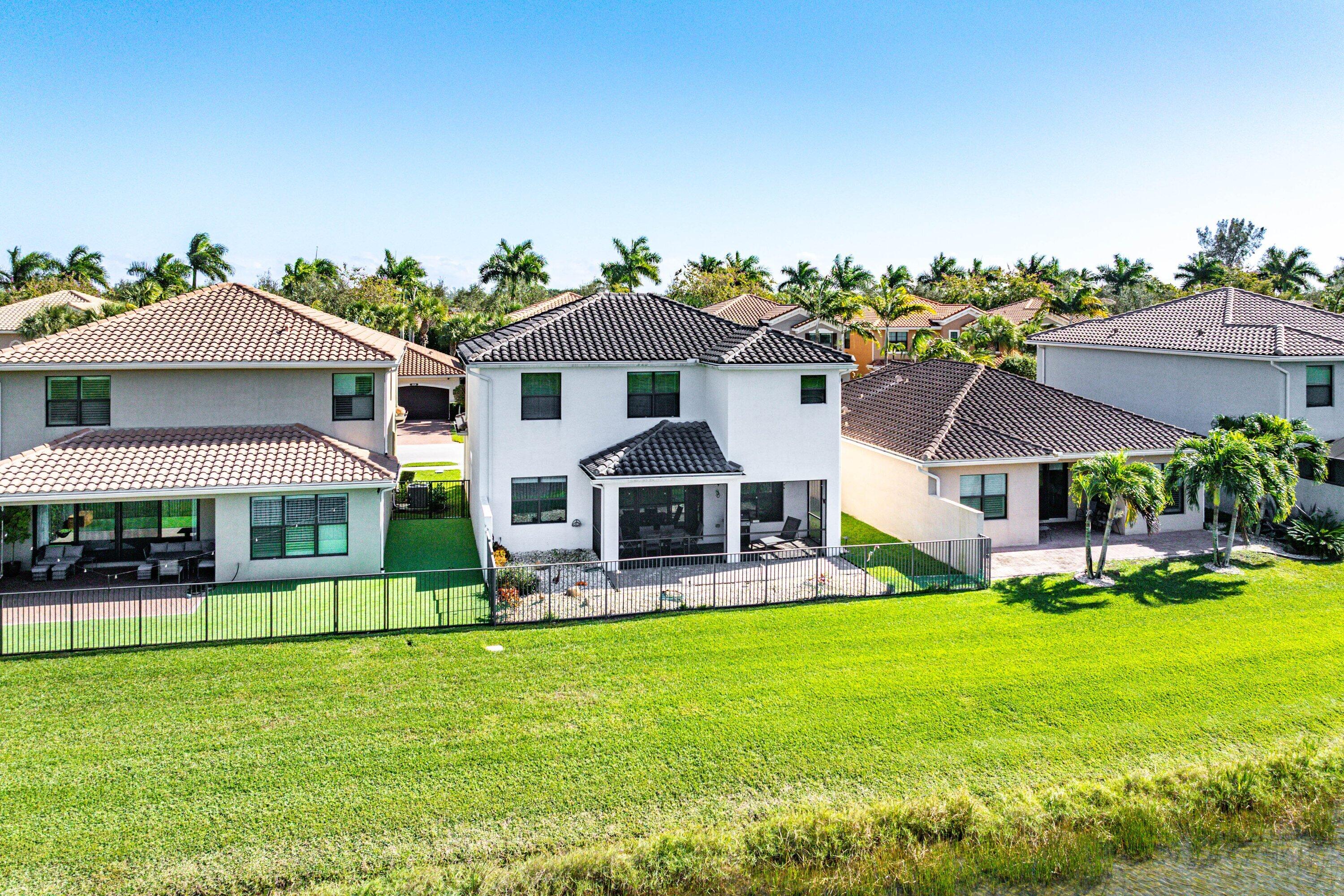 14125 Rock Salt Road Delray Beach, FL 33446 - Photo 39 of 55 a front view of a house with a garden and trees