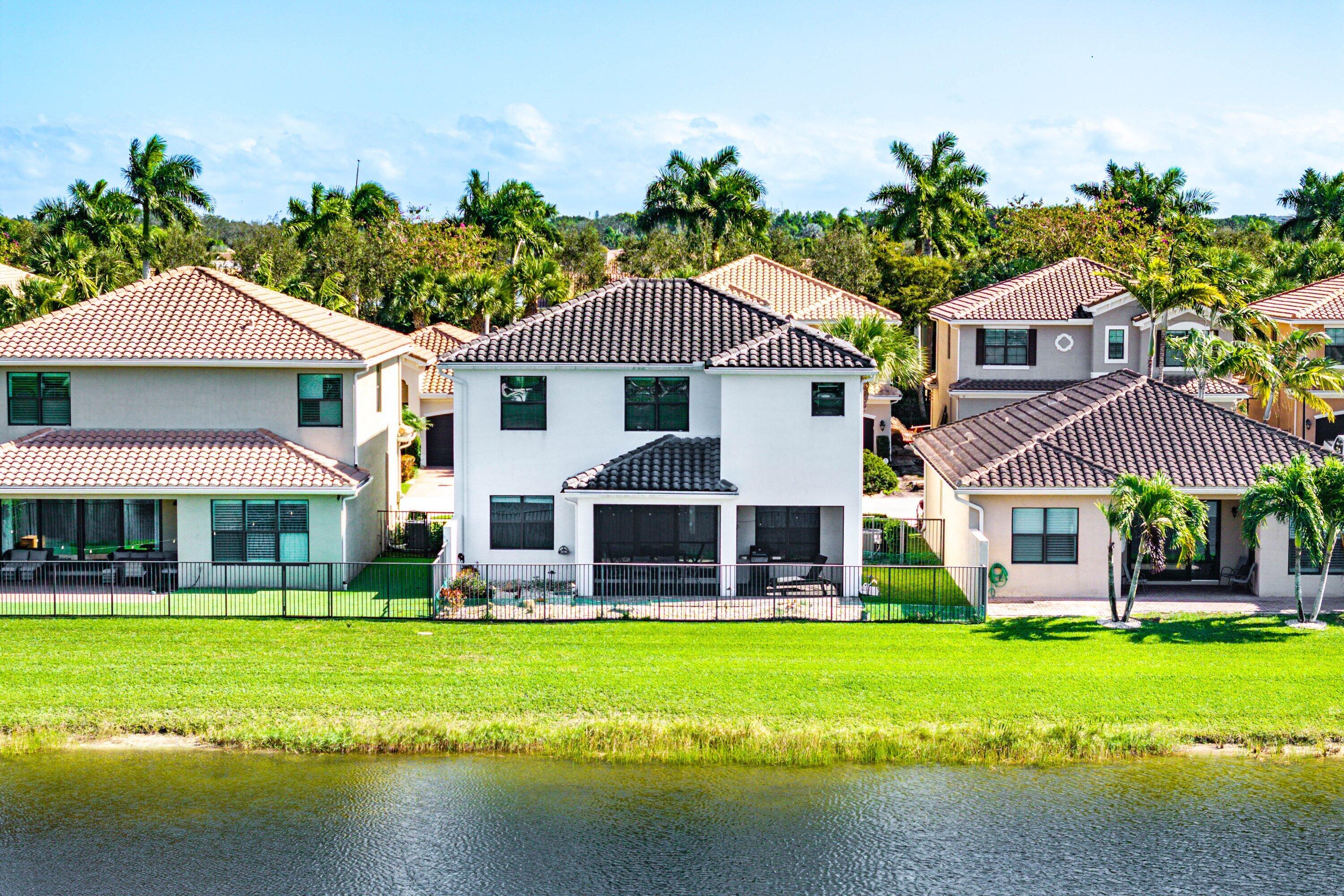 14125 Rock Salt Road Delray Beach, FL 33446 - Photo 41 of 55 a front view of a house with a yard table and chairs