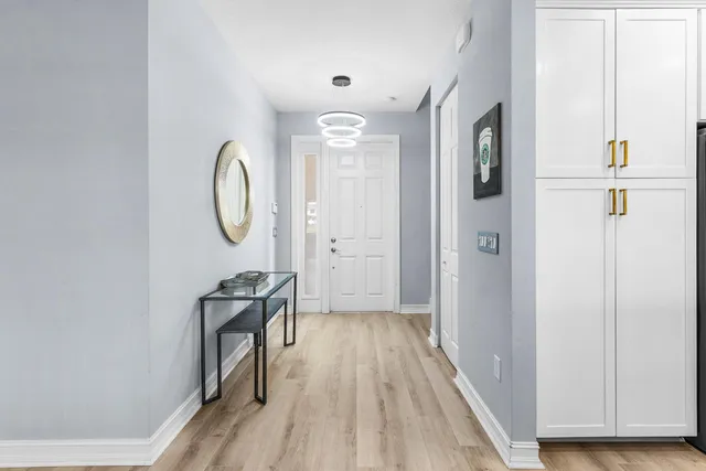 a view of a hallway with wooden floor and glass door
