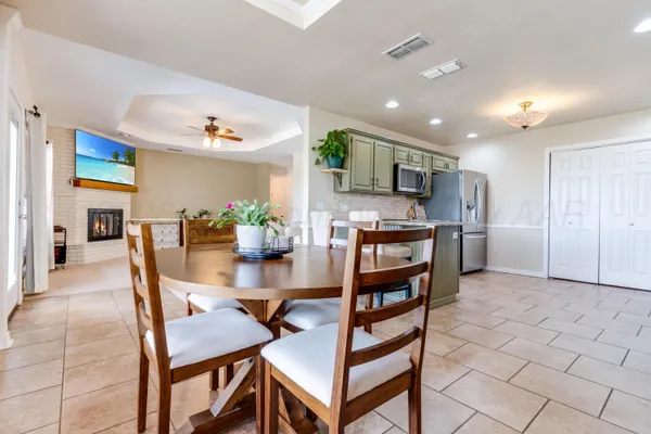 a view of kitchen with kitchen island dining table and chairs
