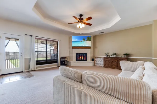 a living room with furniture large window and flat screen tv