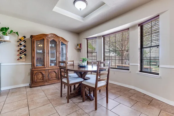 a view of a dining room with furniture and chandelier