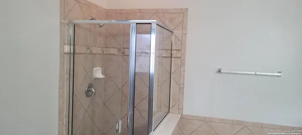a bathroom with a glass shower door