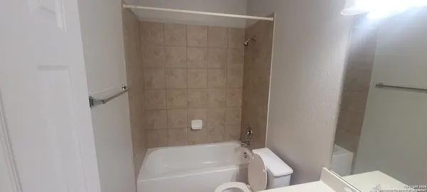 a bathroom with a bathtub and shower