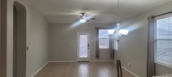 a view of a chandelier fan and wooden floor