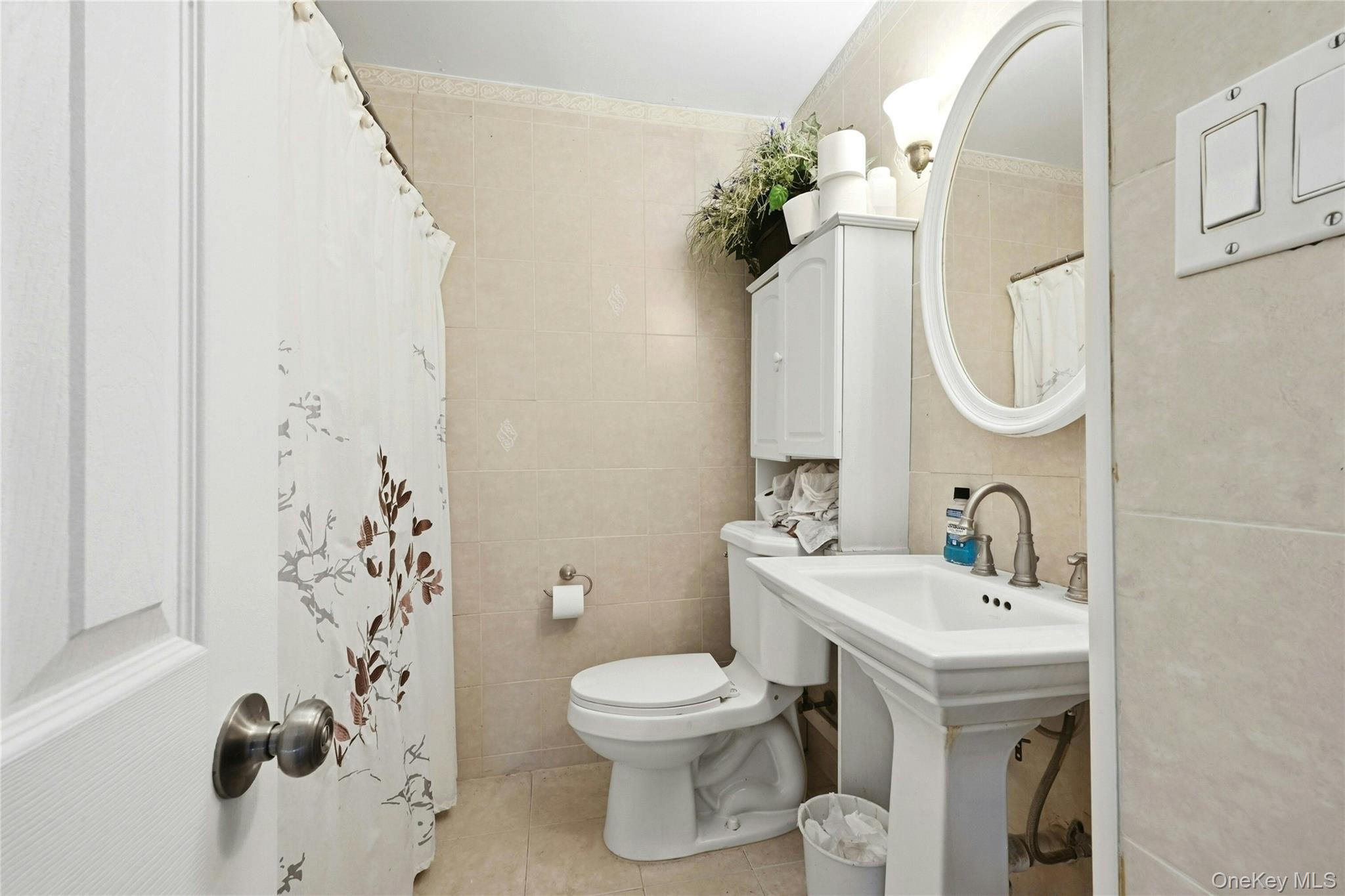 197 Foxhurst Road Oceanside, NY 11572 - Photo 11 of 28 The Main Floor Bathroom Offers All Fully Floor To Ceiling Ceramic Tiled Walls, Ceramic Tiled Floor, Pedestal Sink & Full Bathtub/Shower.