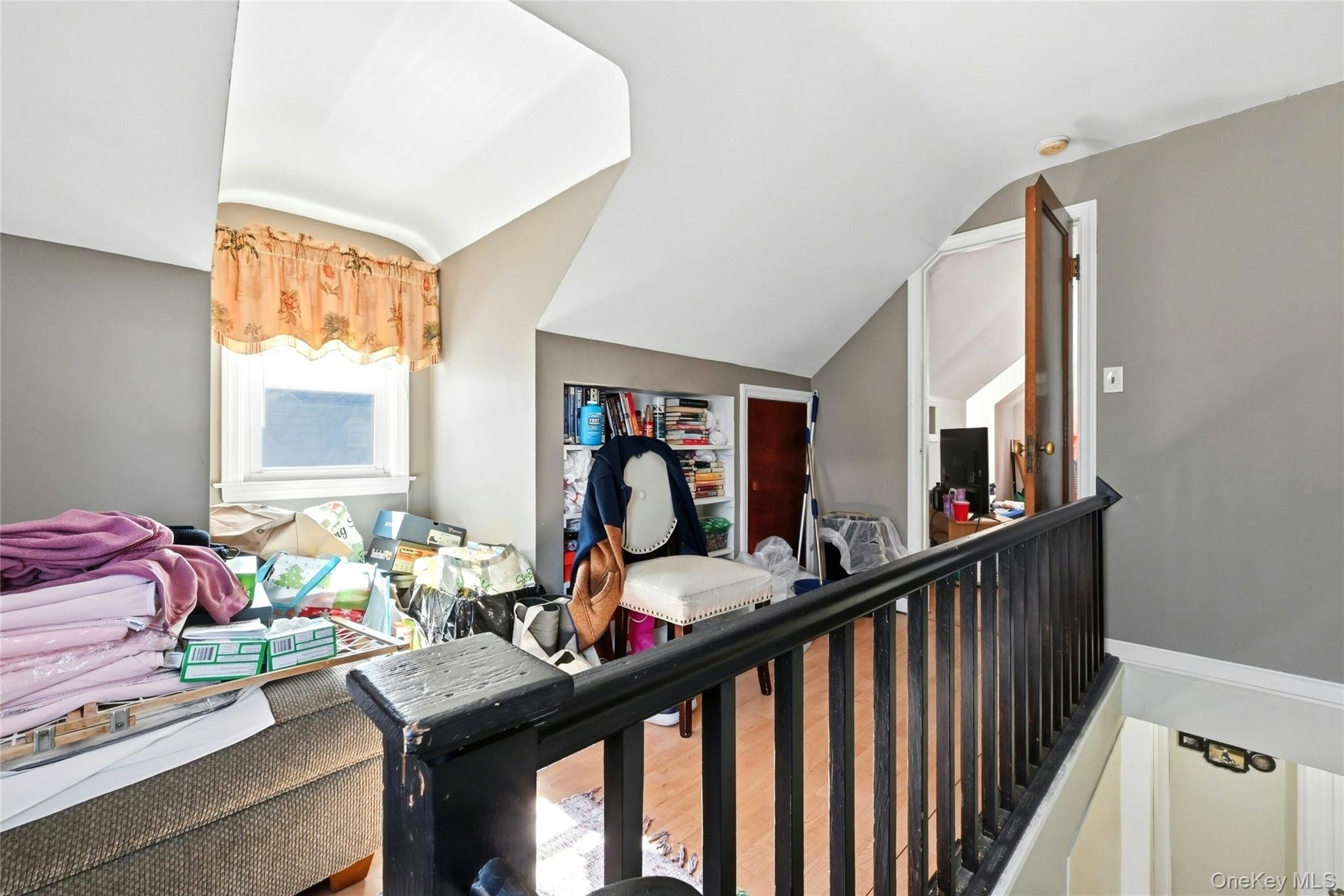 197 Foxhurst Road Oceanside, NY 11572 - Photo 19 of 28 The Stairway To The Second Level Opens Into A Lovely Hallway/Sitting Area With A Charming Arched Doghouse Window And Built In Bookshelves.