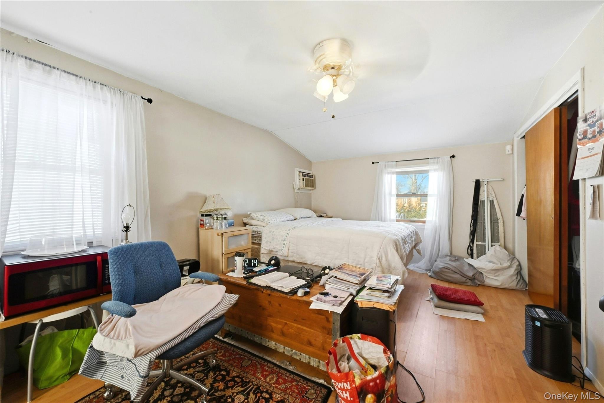 197 Foxhurst Road Oceanside, NY 11572 - Photo 20 of 28 The Back Of The Home Has Been Fully Dormered Creating An Expansive Second Floor Primary Bedroom With Two Large Windows For Natural Light, Two Closets, Laminate Flooring, And Ample Room For A Large Bedroom Set & Separate Seating Area Or Office.
