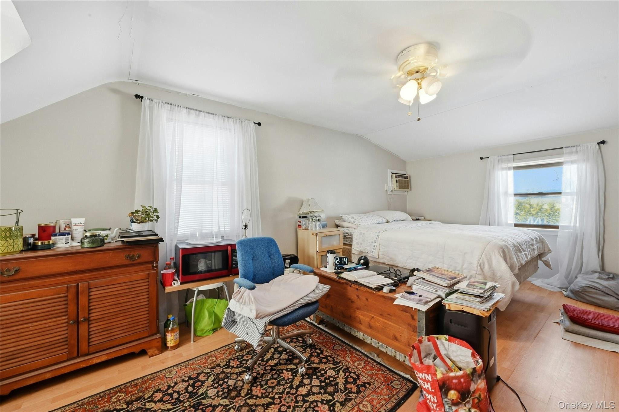 197 Foxhurst Road Oceanside, NY 11572 - Photo 21 of 28 Another View Of The Expansive Primary Bedroom Offering Ample Room For A Large Bedroom Set & Separate Seating Area Or Home Office, Two Large Windows For Natural Light, Two Closets & Laminate Floors.