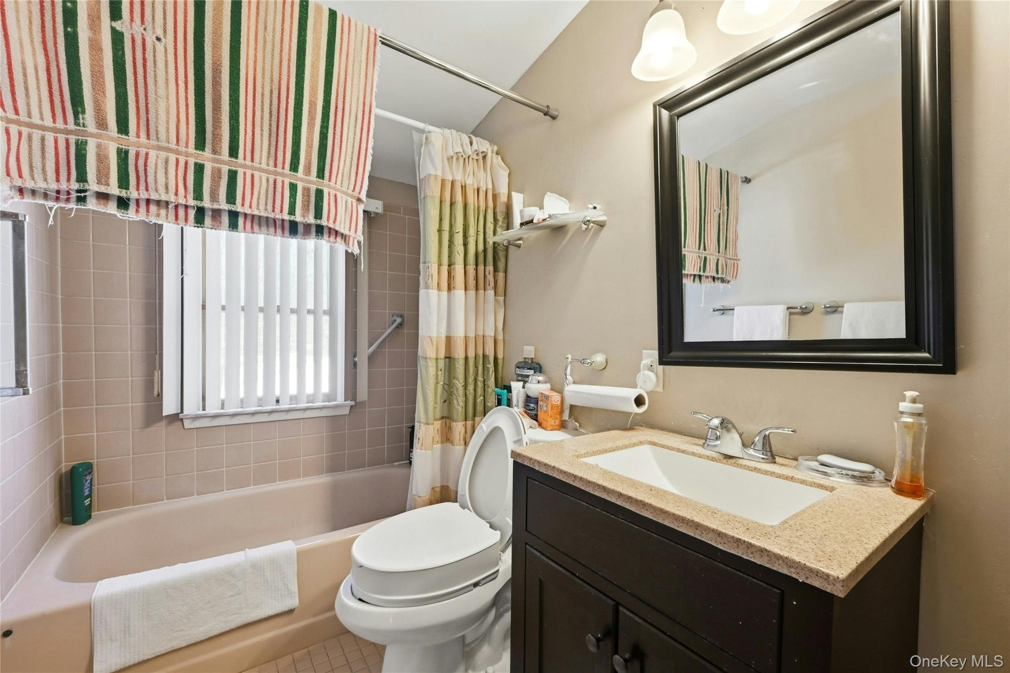 197 Foxhurst Road Oceanside, NY 11572 - Photo 22 of 28 The Lovely Second Floor Full Bathroom Offers An Updated Stone Topped Vanity & Fixtures. Full Bathtub With All Fully Ceramic Tiled Walls/Tub Surround, Large Window For Natural Light & Ceramic Tiled Floors.