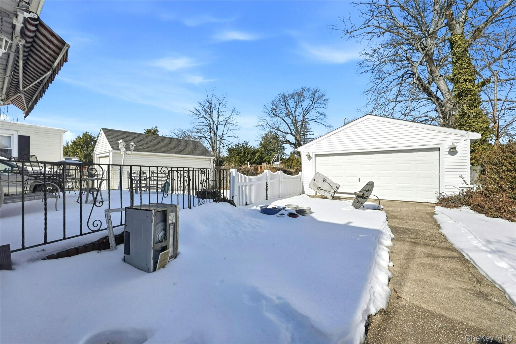 197 Foxhurst Road Oceanside, NY 11572 - Photo 26 of 28 A Long Concrete Driveway Leads To The Oversized Two+ Car Detached Garage (Perfect For A Mechanic, Landscaper Or Auto Enthusiast), And The Oversized Backyard.
