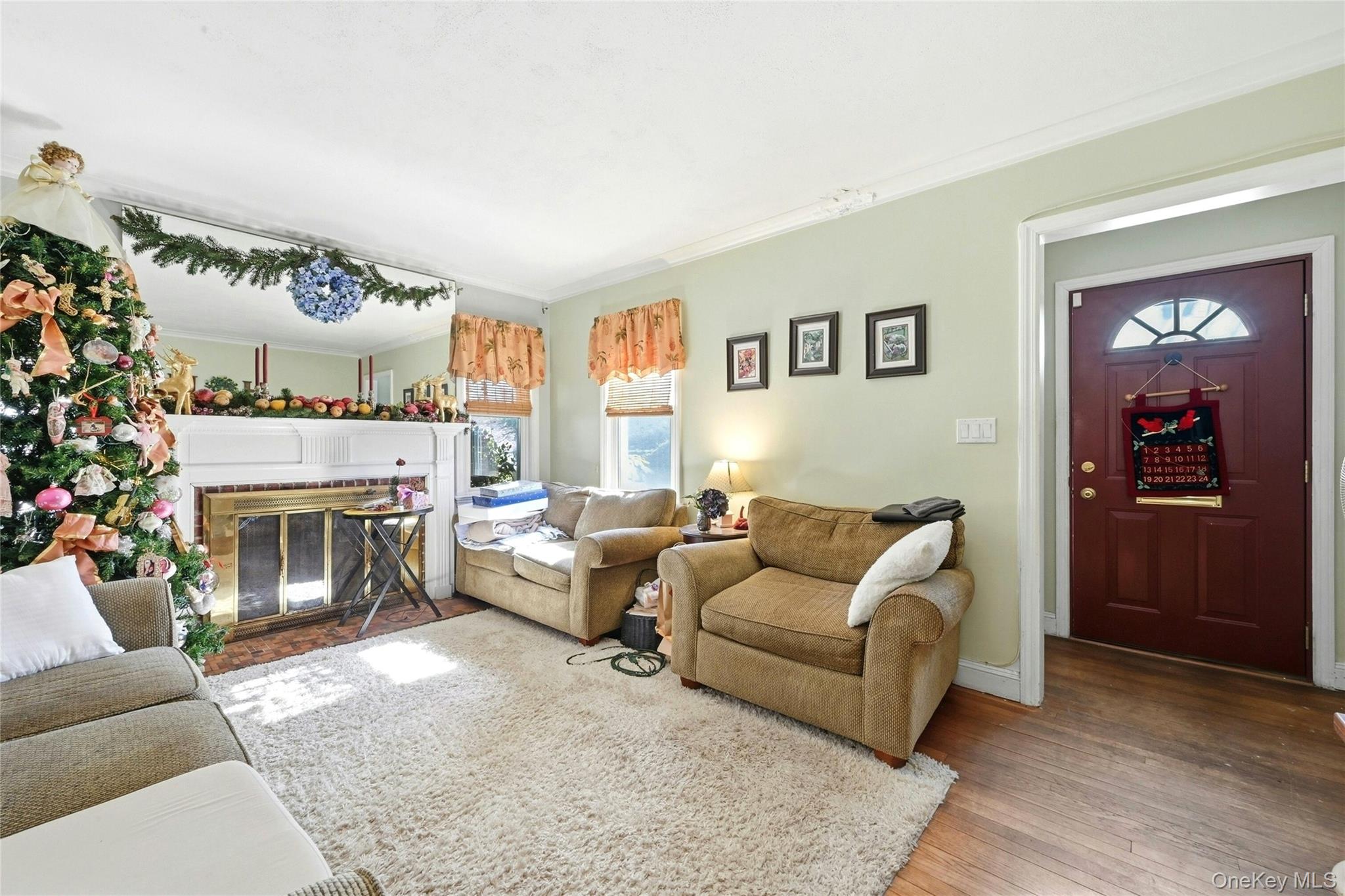 197 Foxhurst Road Oceanside, NY 11572 - Photo 6 of 28 A Lovely Entrance Foyer With A Good Sized Closet Opens Into The Warm & Inviting Formal Living Room Offering A Beautiful Brick Wood Burning Fireplace With Custom Mantel, Hardwood Floors, Large Windows For Natural Light & Ample Room For A Nicely Sized Living Room Set/Furniture.