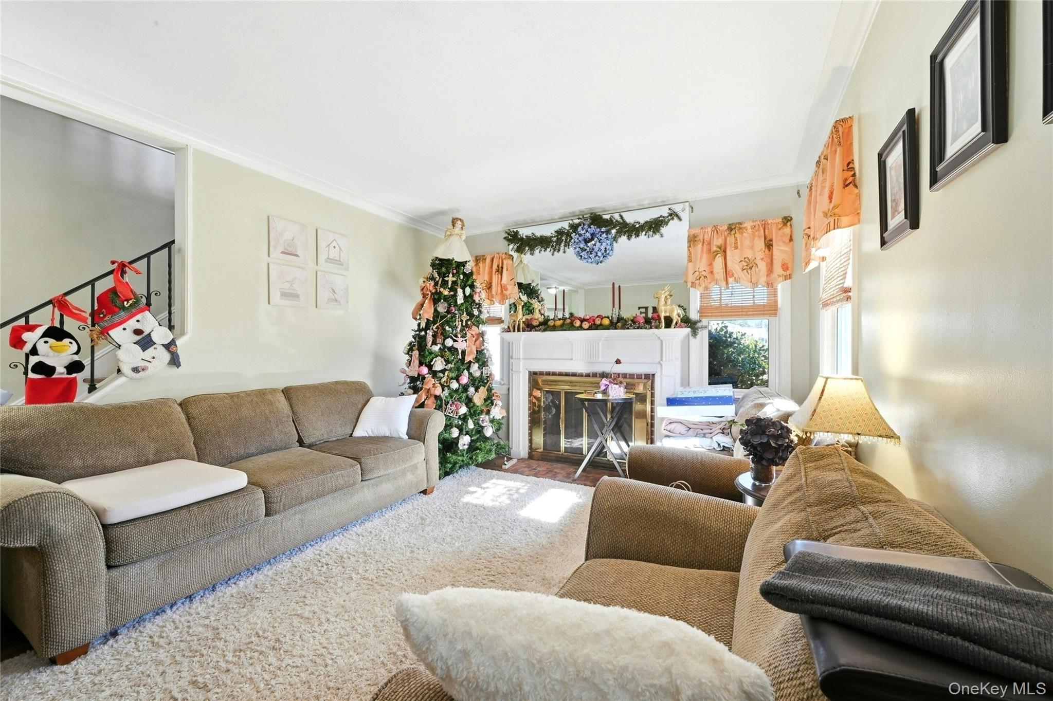 197 Foxhurst Road Oceanside, NY 11572 - Photo 7 of 28 The Warm & Inviting Formal Living Room Offers a Beautiful Focal Point Brick Wood Burning Fireplace With Custom Mantel Flanked By Two Large Windows For Natural Light, Hardwood Floors, Beautiful Crown Moldings & Ample Room For A Good Sized Living Room Set/Furniture.