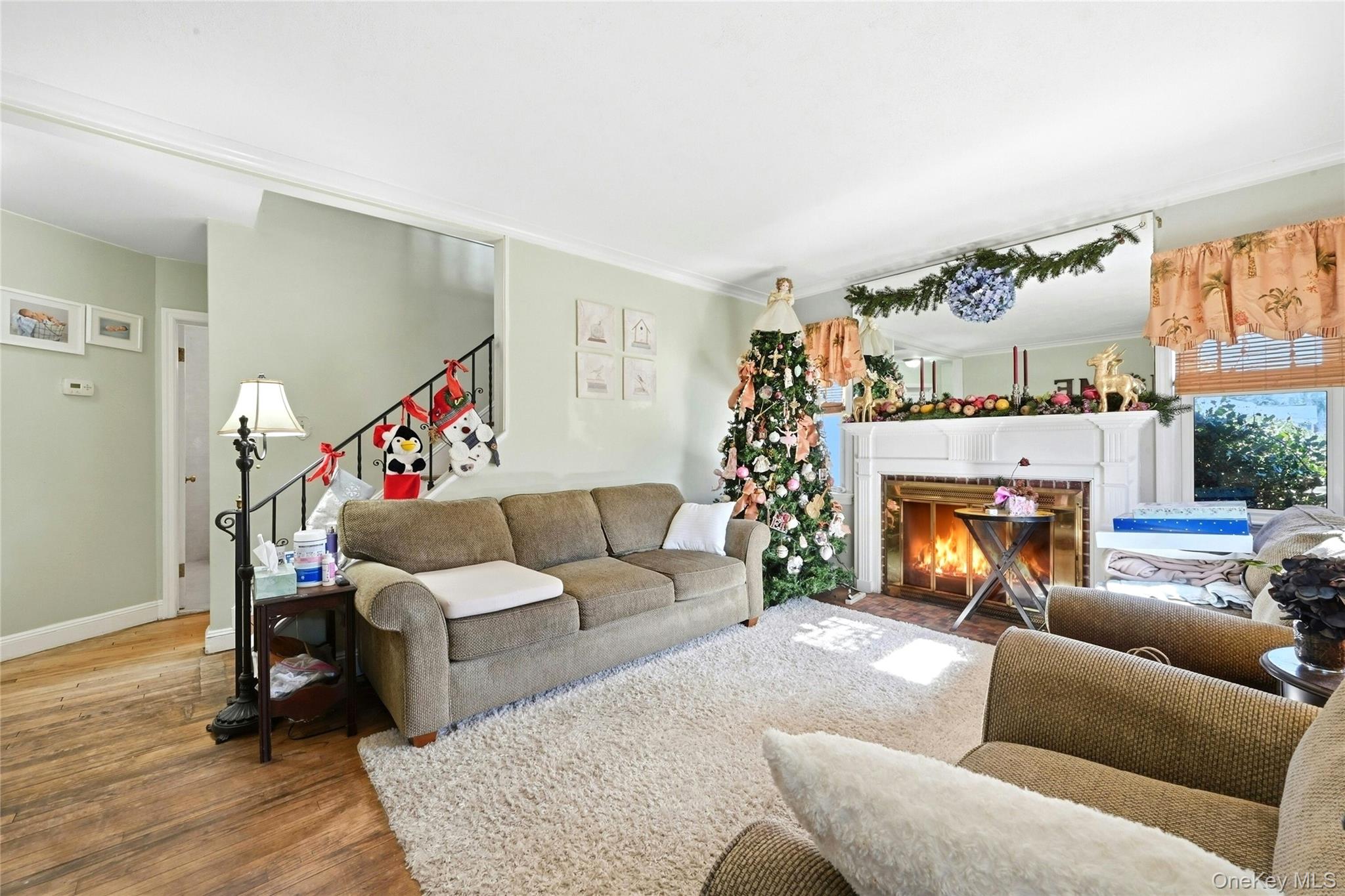 197 Foxhurst Road Oceanside, NY 11572 - Photo 8 of 28 The Comfortable, Warm & Inviting Formal Living Room Offers A Beautiful Brick Fireplace & Custom Mantel, Three Windows For Natural Light, Hardwood Floors, And Opens Into The Hallway To The Rest Of The First Floor & The Stairway To The Second Level.